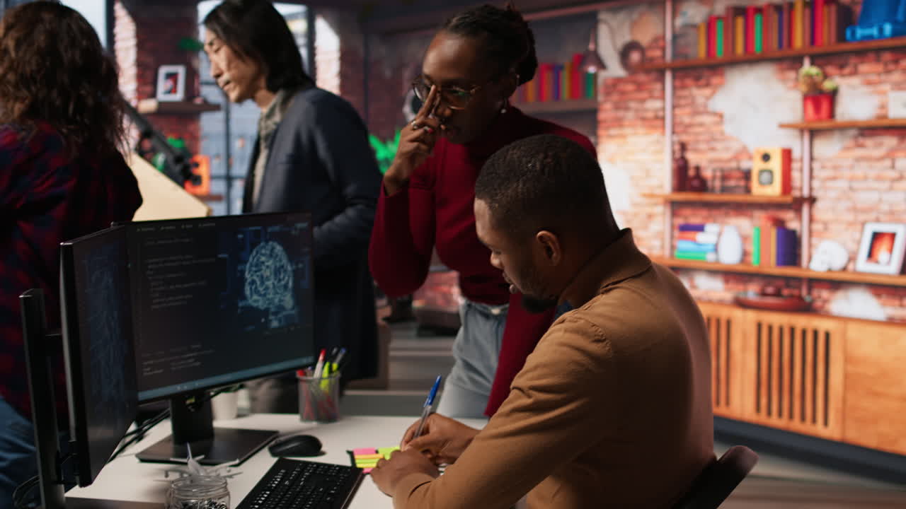 Teamworking startup engineers writing message on sticky notes
