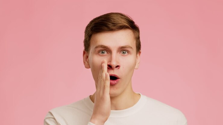 Surprised Young Man Whispering