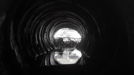 damaged concrete drainage pipe, collector of city sewage system, view fron inside, timelapse.