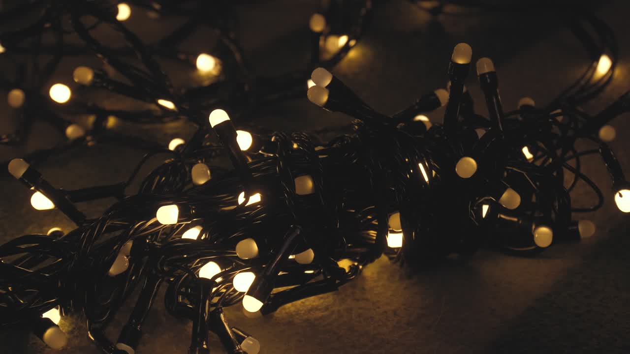 Close-up shot hank of christmas garland with golden lights on a playd. Christmas concept. Home decor