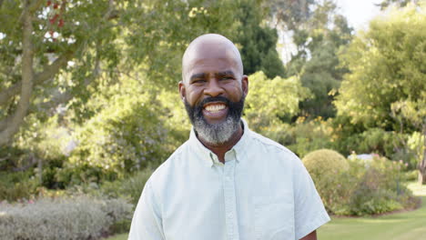 smiling man standing outdoors in garden, enjoying nature and fresh air