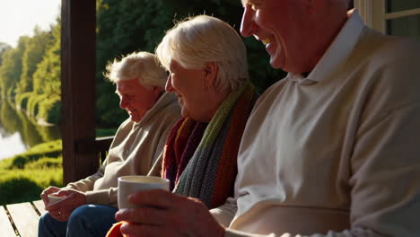 elderly couple relaxing on porch overlooking river