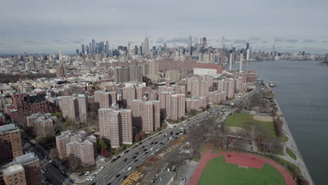 aerial view of sports field with quarter mile running track beside the east river and fdr drive in brooklyn