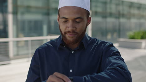 Young-middle-eastern-businessman-portrait-looking-at-watch-confident-office-campus-corporate