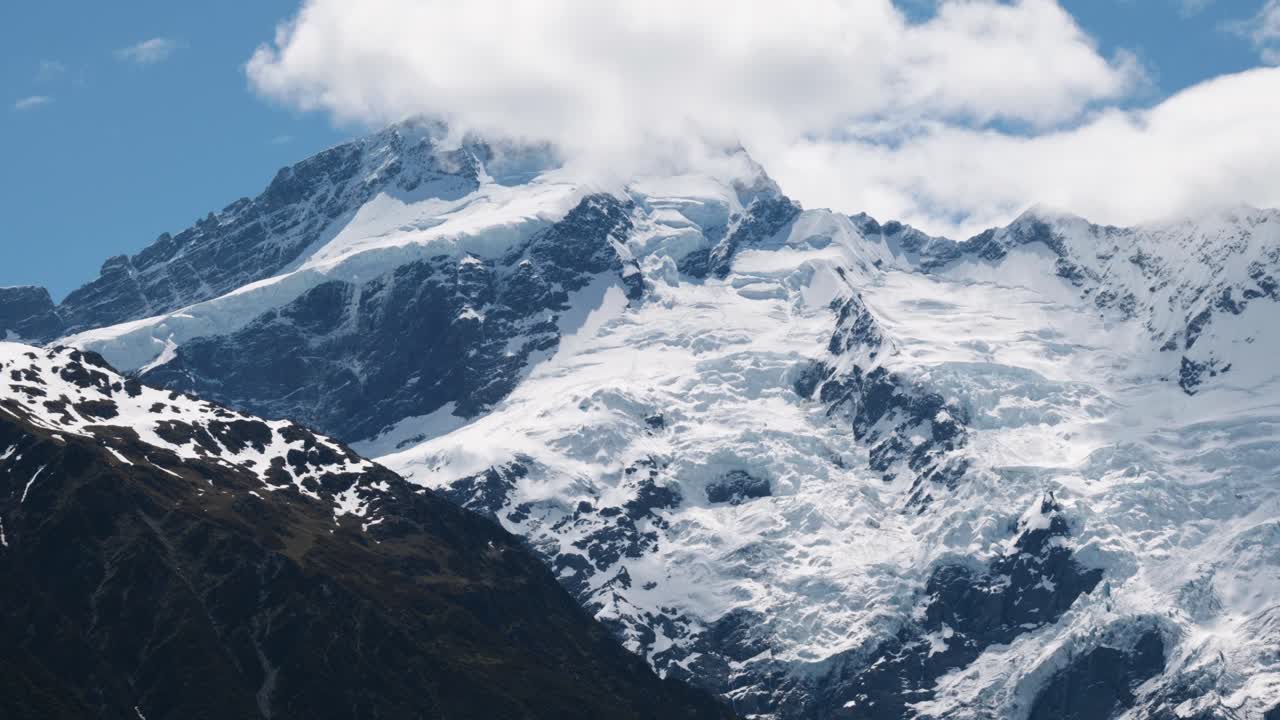 Close up view of snowy mountains, glaciers and Mount Sefton on a sunny summer day in Mount Cook National Park, New Zealand.