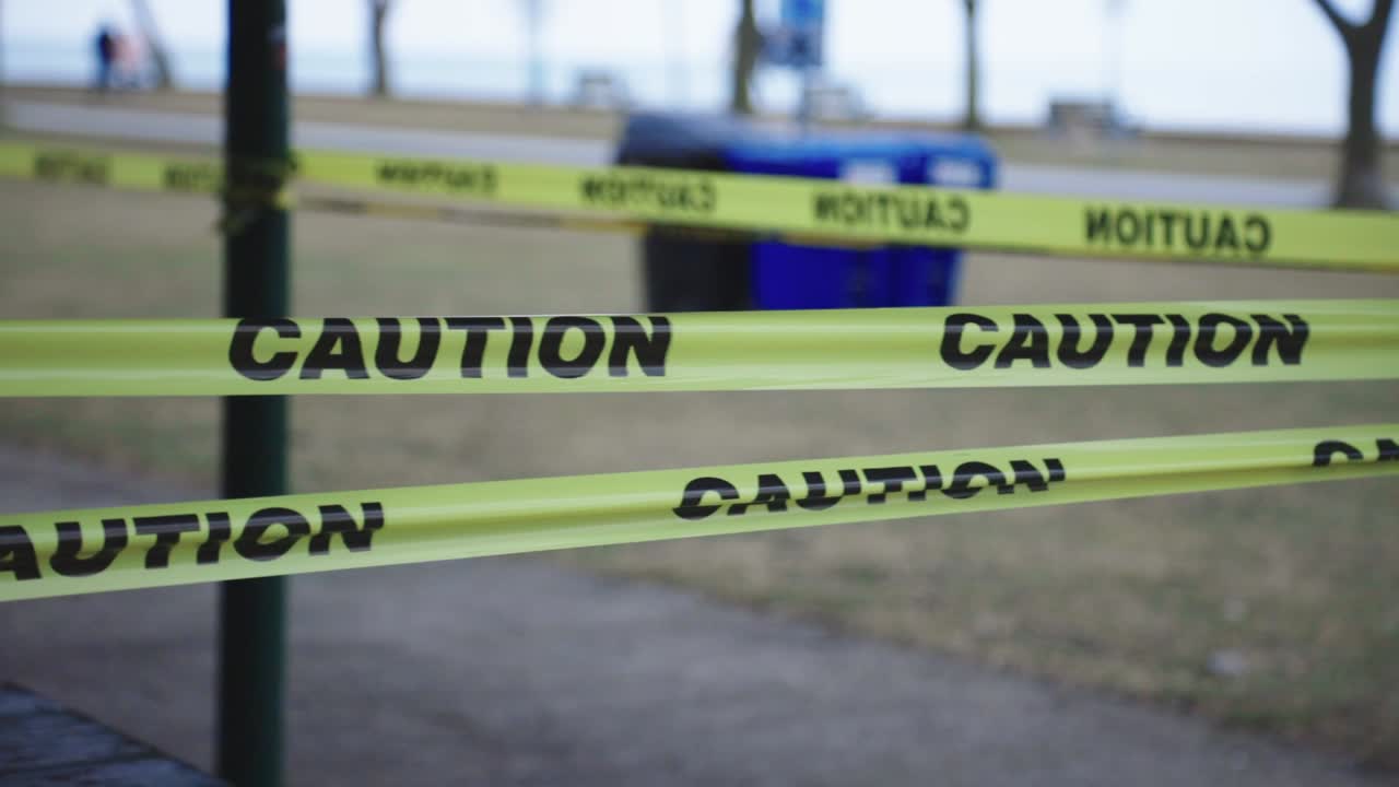 Caution Tape Around A Closed Picnic Area In A Public Park During Quarantine Period Due To COVID-19 Outbreak - Panning Shot