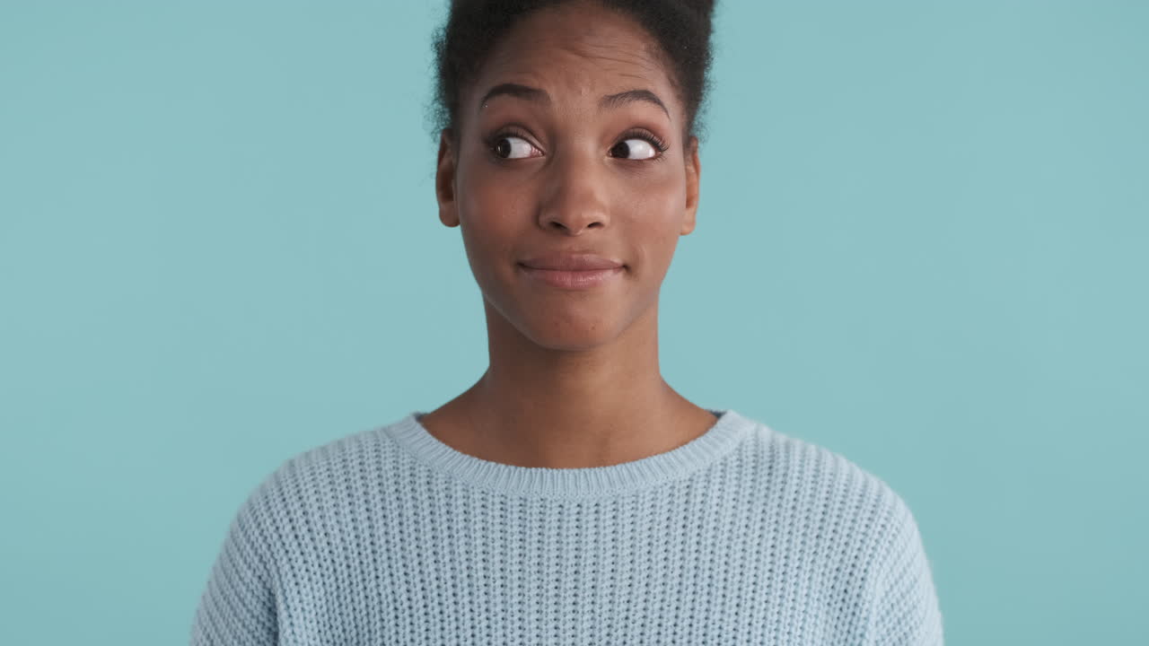 Woman in blue sweater doing faces