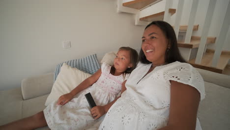 mother and daughter watching tv