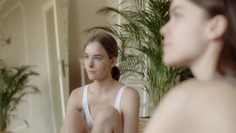two young women relaxing at home