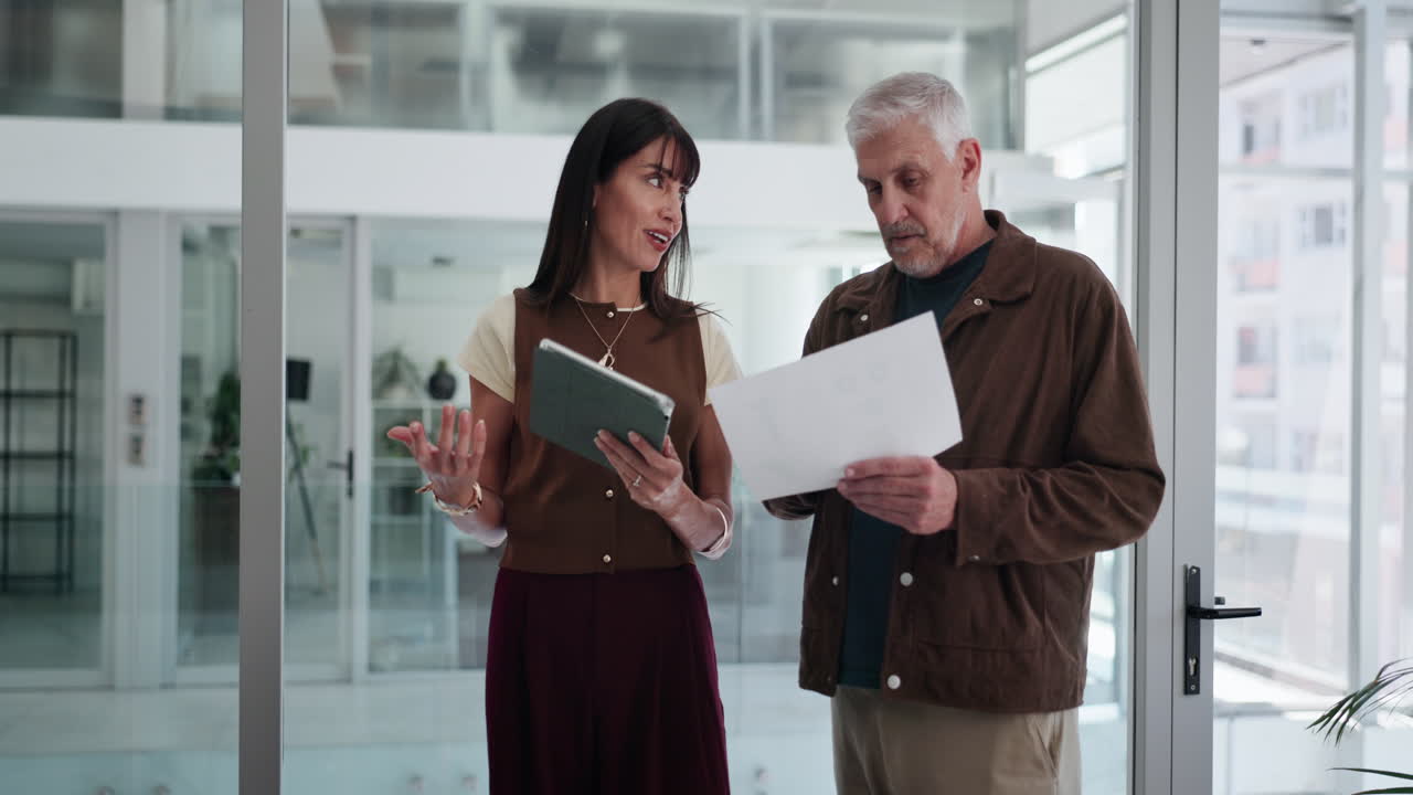 Professional Colleagues Discussing Business Strategy with Tablet and Documents