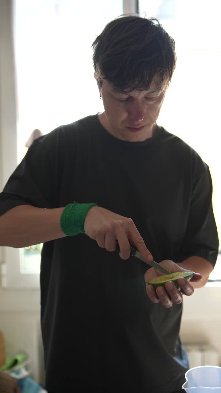 Person cutting lime and avocado