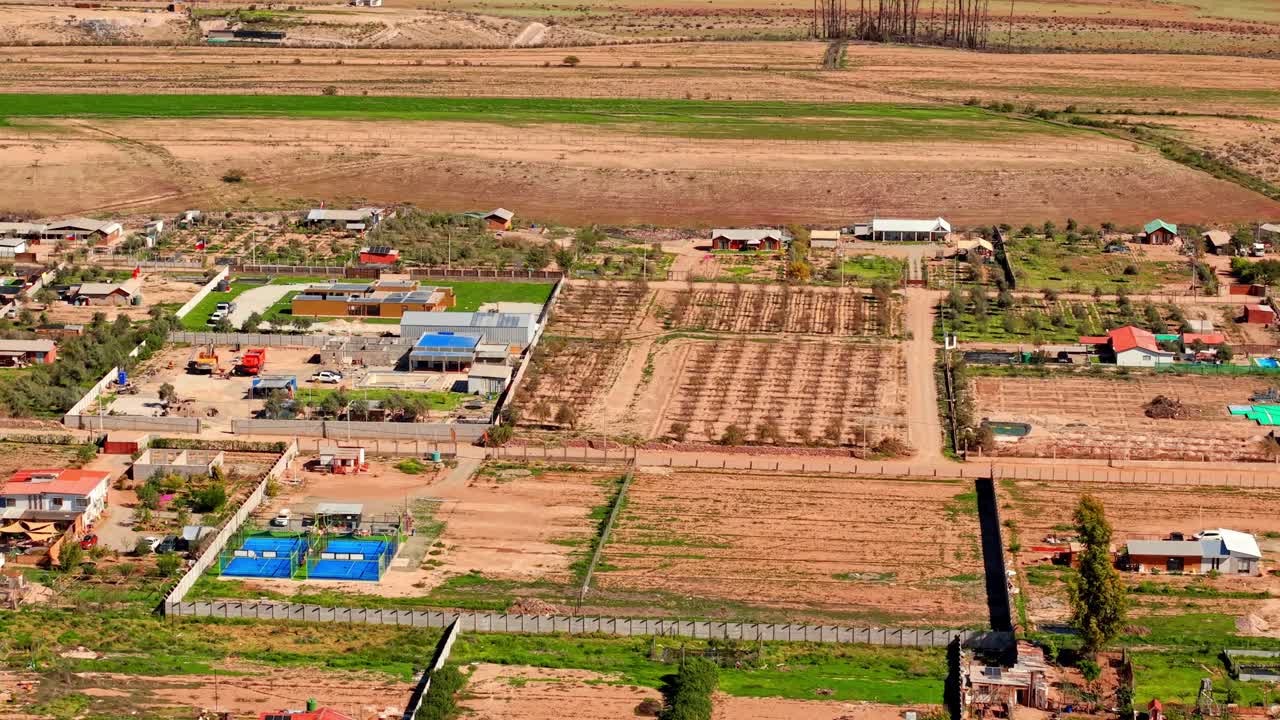 Aerial view establishing small parcels with grapevines planted for production on a sunny day