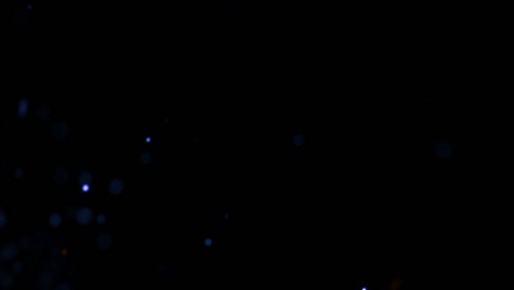 volar pequeñas partículas azules y doradas con humo oscuro