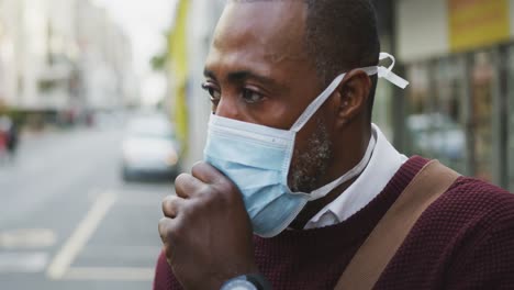 african american man on the go wearing coronavirus covid19 mask