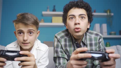 The-young-man-plays-competitive-games-with-his-younger-brother-at-home.