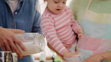 Handheld-view-of-family-baking-cookies-for-Easter