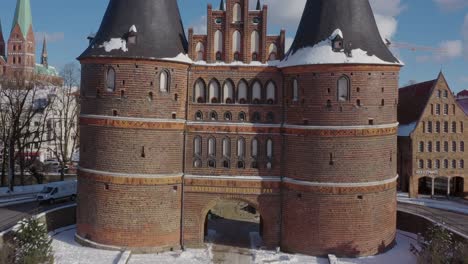 aerial view of the holsten gate in lübeck after snowing