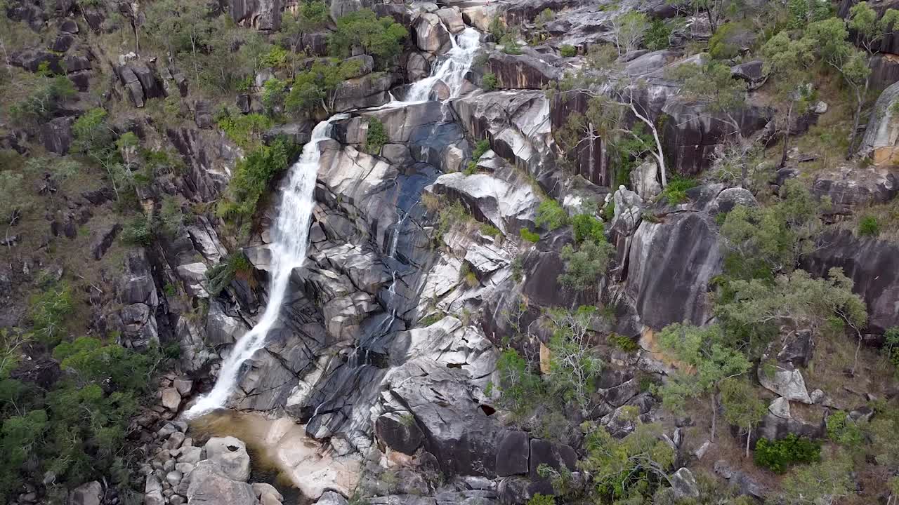 paisaje de davies creek falls que fluye sobre los acantilados rocosos durante el verano en queensland, australia