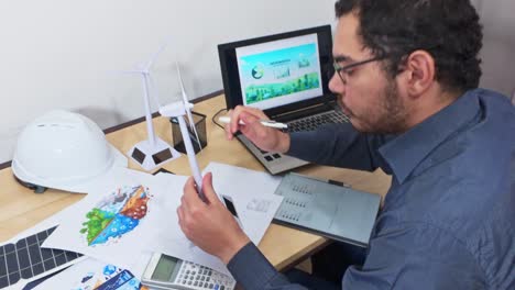 engineer assembling a small-scale wind turbine model for study