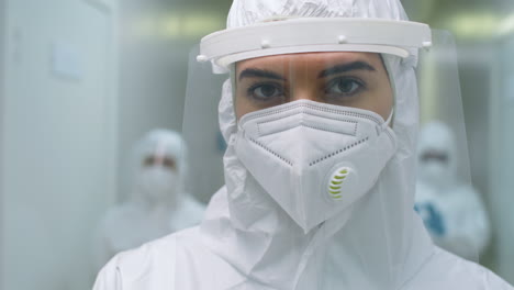 portrait of young female doctor in protective uniform