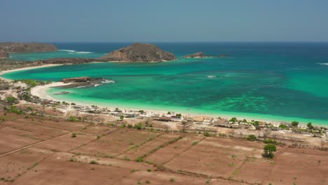 the white sand beach of tanjung aan in lombok, indonesia during a sunny day