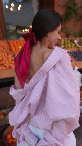 young woman at a fruit stand