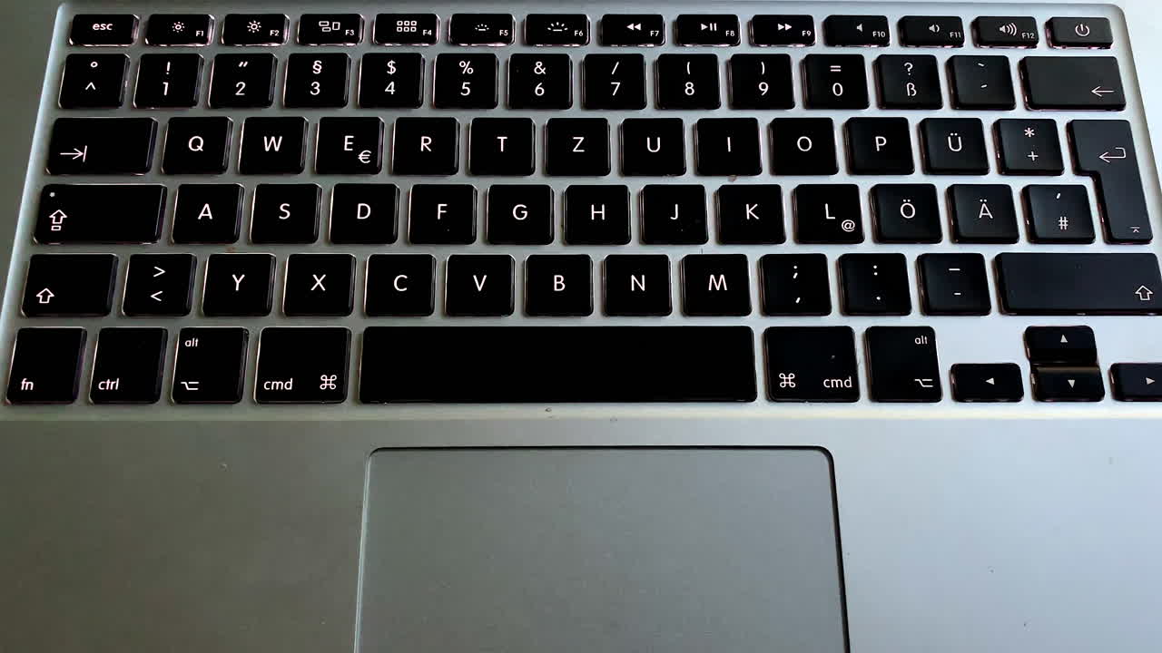 Apple Macbook Pro keyboard lights up at night. Modern design