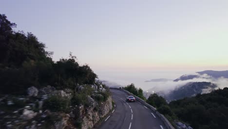 Old-vintage-car-driving-in-the-French-mountains-outside-Monaco