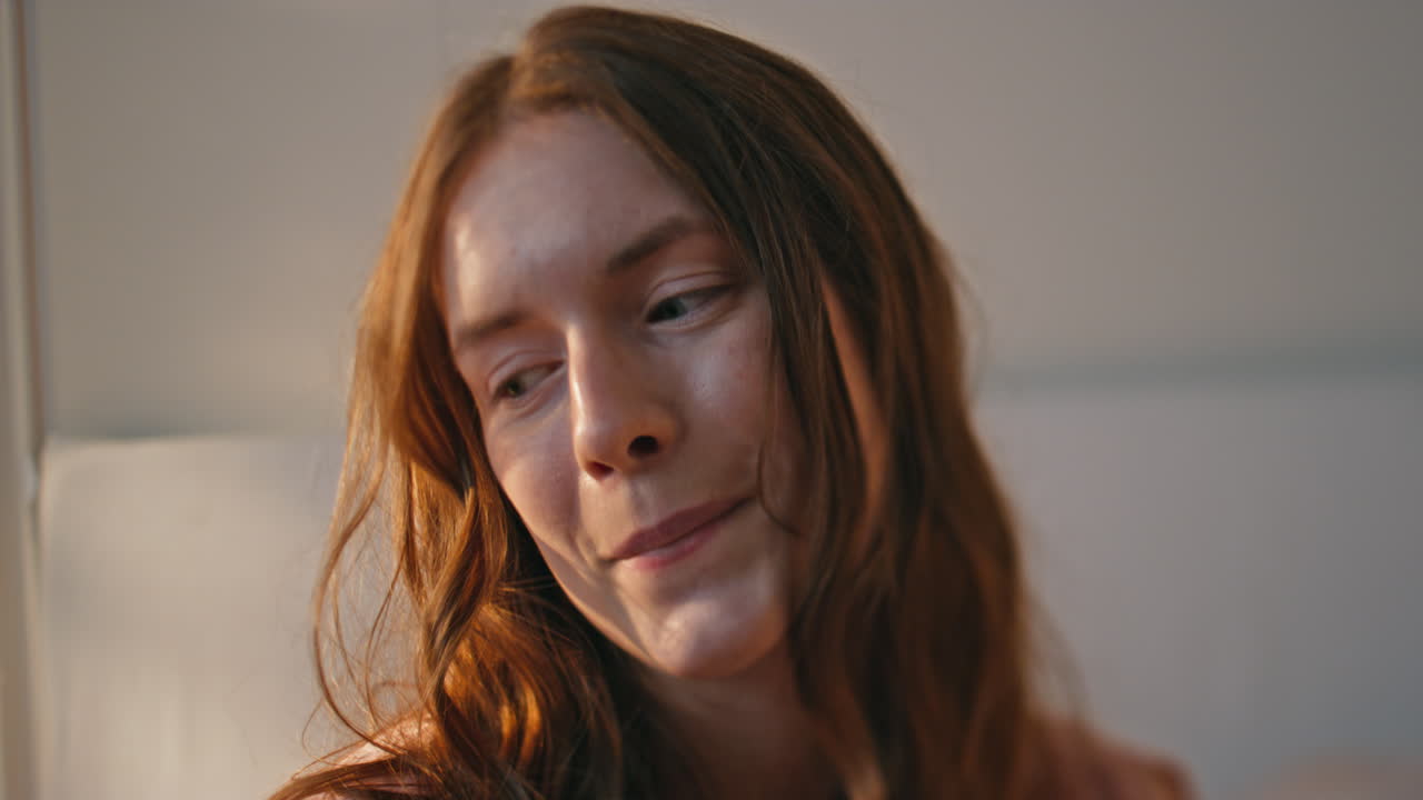 Satisfied woman holding smartphone in sunlight closeup. Happy teenager in love