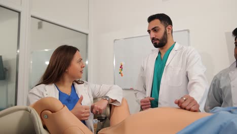 students actively engage in practical training sessions using a detailed medical simulation mannequin for learning