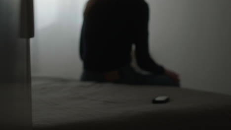 woman sitting on bed, night