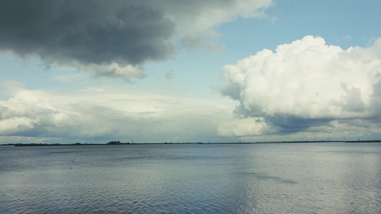 Panning on a landscape with clouds and the calm sea water