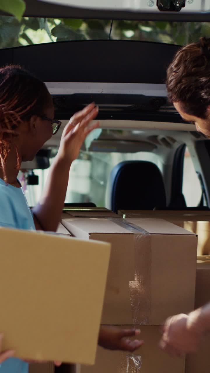 Vertical video Volunteers at food drive give donations