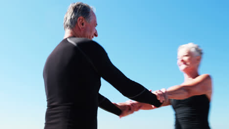 senior couple dancing on beach