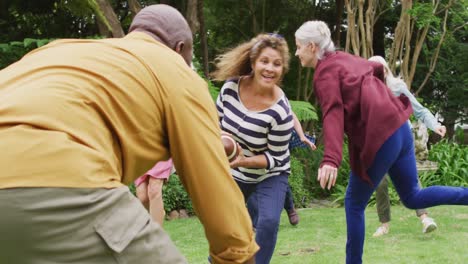 animation of happy diverse female and male senior friends playing american football in garden