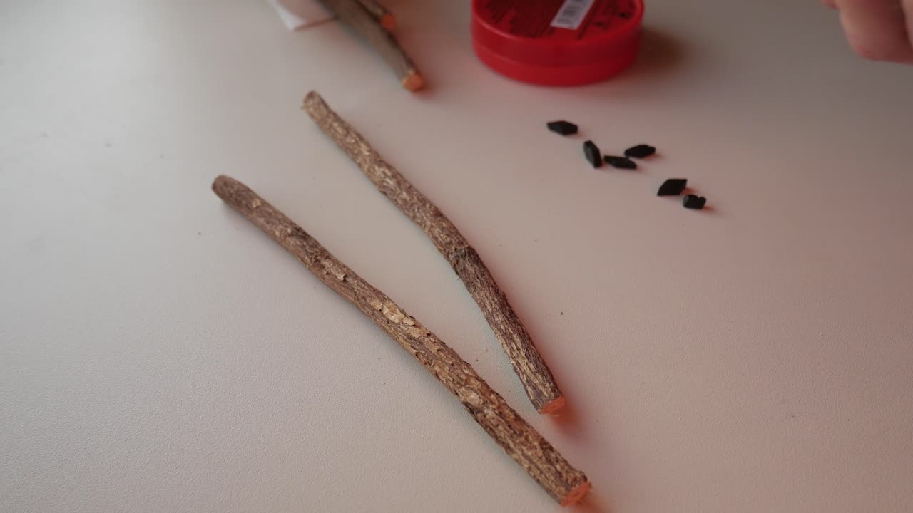 Natural liquorice root and dark mints on white table, healthy snack or herbal remedy