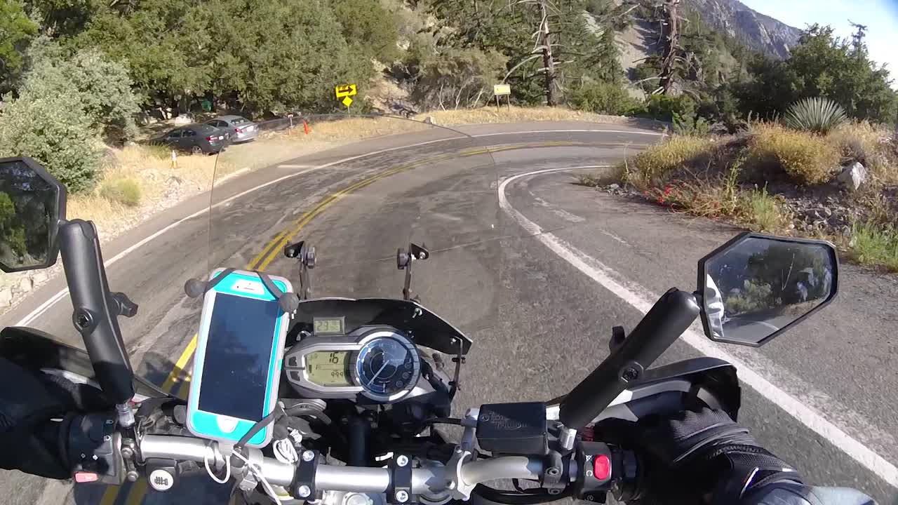 Driving motorcycle down the road on Mount Baldy, California on sunny day