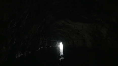 Boat-traveling-through-the-limestone-cave-in-Ha-Long-Bay-Vietnam