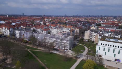 big-Building-crane,-Magic-aerial-top-view-flight-Berlin-City-Construction-work-on-house-with-crane