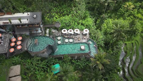 aerial view of multi-level swimming pool at ceking rice terraces, bali