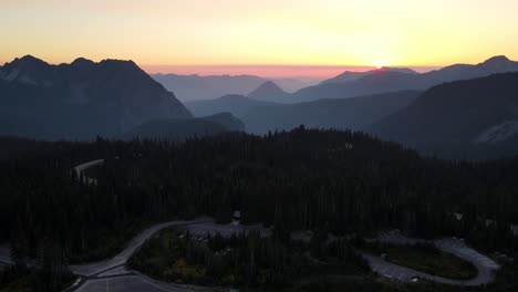 Drone-captures-an-aerial-shot-of-the-sun-rising-from-the-horizon-and-Mount-Rainier-National-Park-in-Washington-state