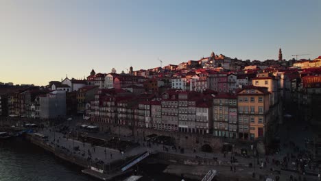 Stunning-sunset-Drone-shots-of-the-Douro-River-in-the-heart-of-Porto,-Portugal