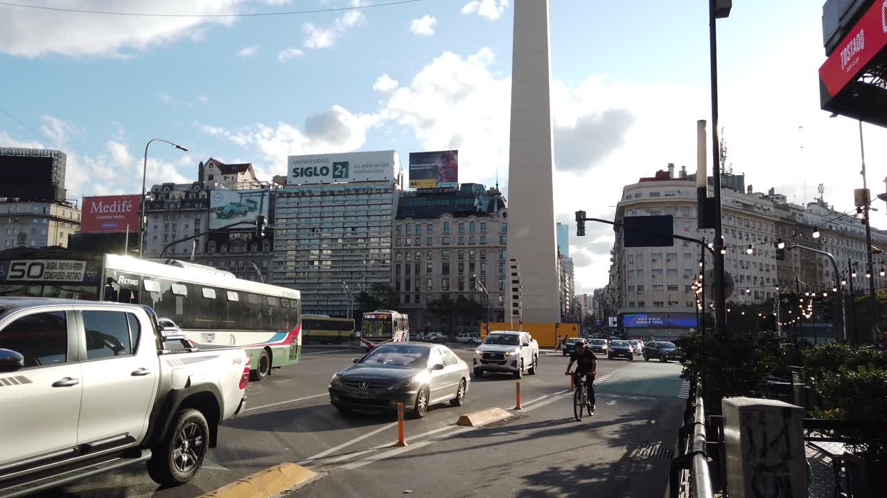 Buenos Aires capital Argentine city traffic at central 9 de Julio and Corrientes avenue, daylight sunny skyline in famous landmark, commercial area