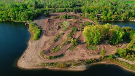 amazing aerial off road dirt bike motocross tracks next to a lake and forest