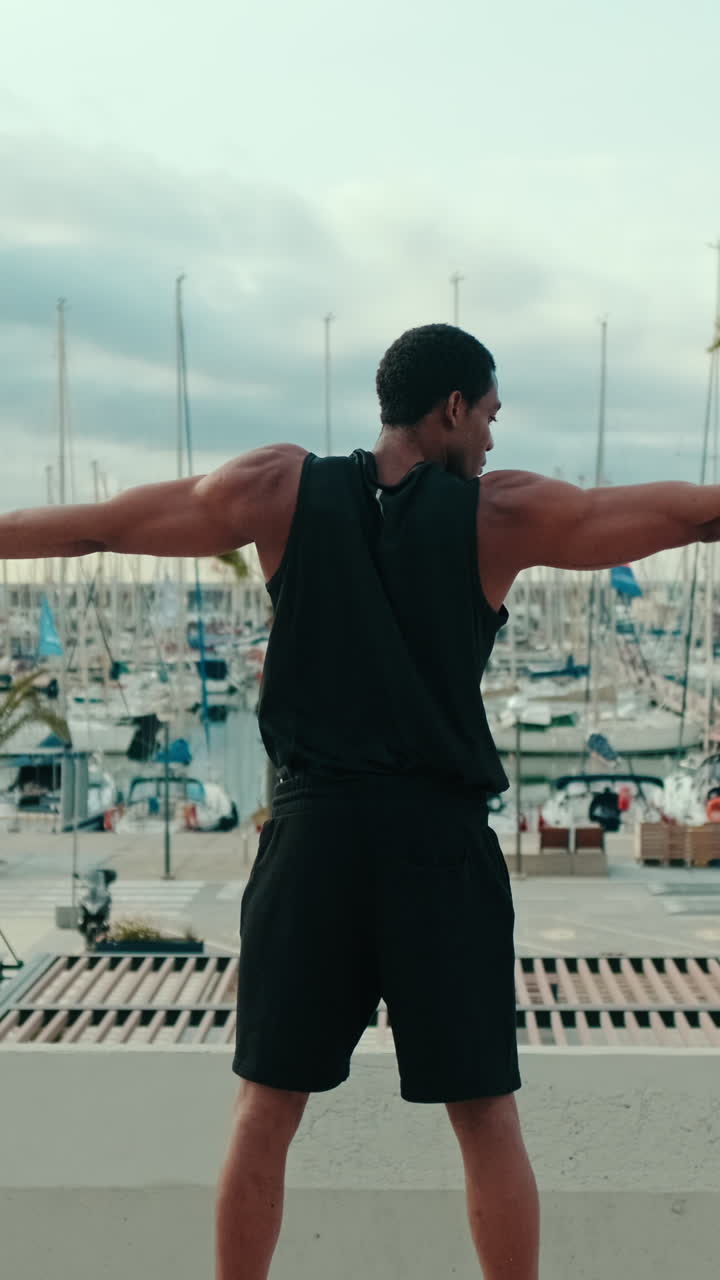 Muscular Man Stretching By The Marina