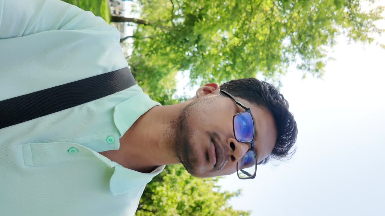 Man with glasses wearing polo shirt