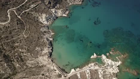 Transparent-vibrant-blue-waters-surround-a-holiday-beach-town-on-the-Mediterranean