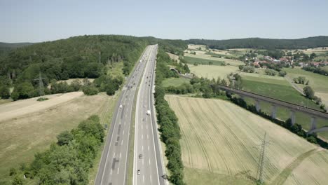 drone shot of summer holiday traffic on the german motorway a7 in sunlight, germany, europe