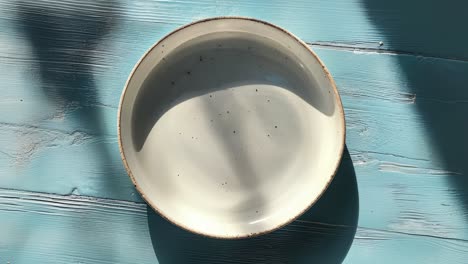 empty white ceramic plate on blue table