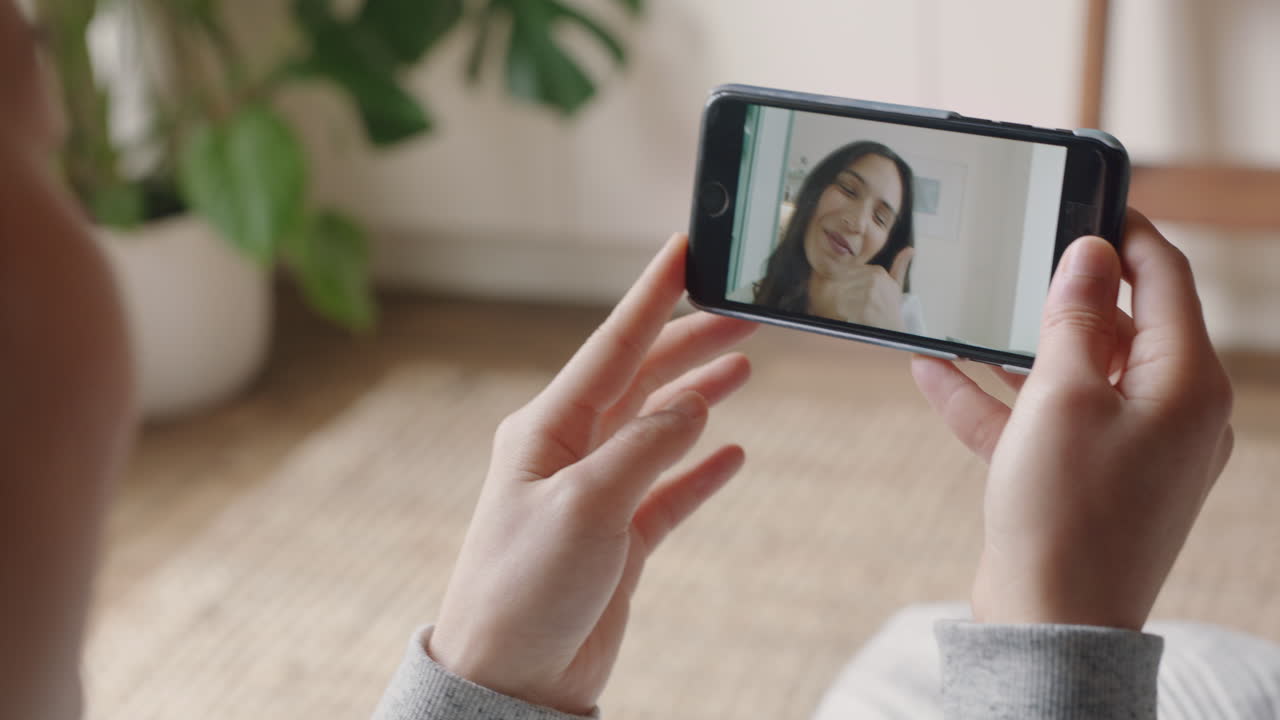 mujer joven teniendo video chat usando teléfono inteligente en casa hablando con un amigo disfrutando de la conversación compartiendo estilo de vida en el teléfono móvil